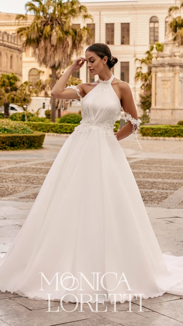 Abito da sposa Monica Loretti con pizzi raffinati e silhouette romantica.